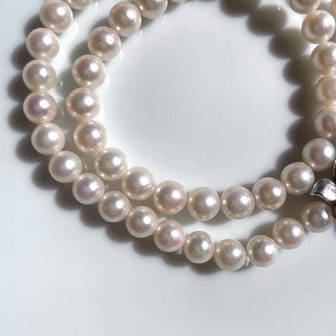 Akoya pearl necklace with 6mm white pearls and silver clasp showing pink and green interference colors