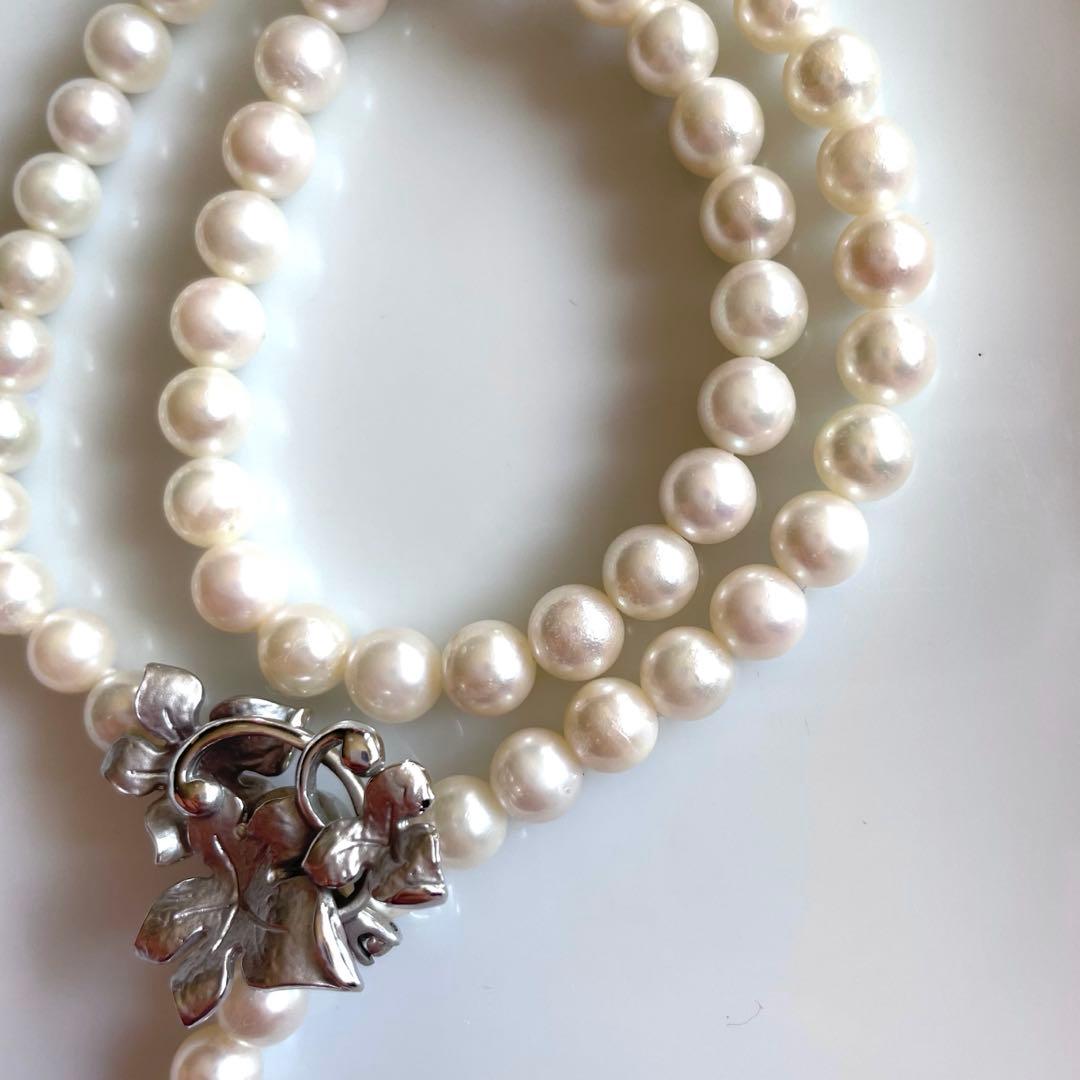 Akoya pearl necklace with 6mm white pearls and silver clasp showing pink and green interference colors