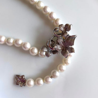 Akoya pearl necklace with 6mm white pearls and silver clasp showing pink and green interference colors