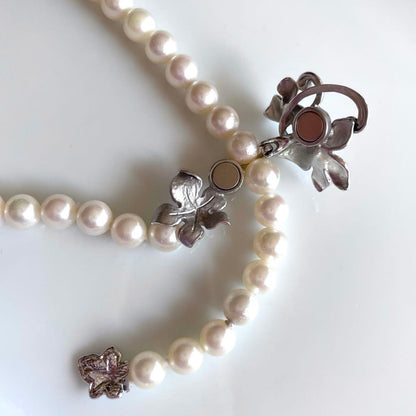 Akoya pearl necklace with 6mm white pearls and silver clasp showing pink and green interference colors