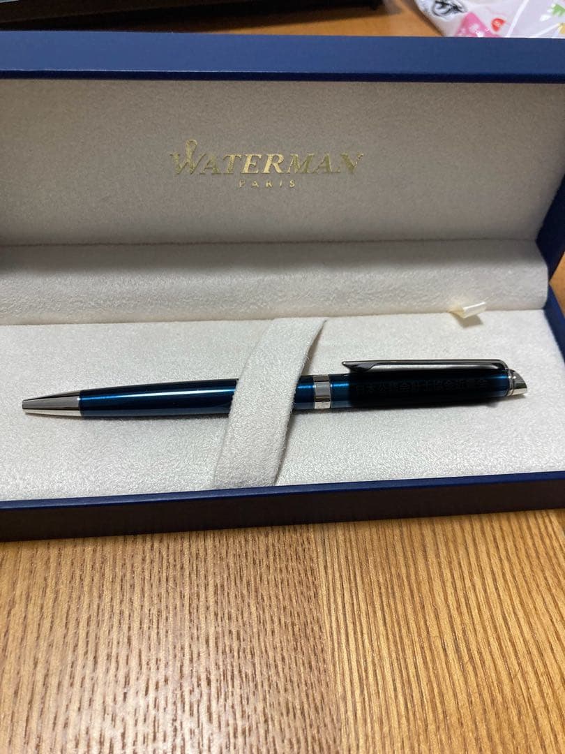 WATERMAN ballpoint pen with engraved organization name on the body, shown in close-up