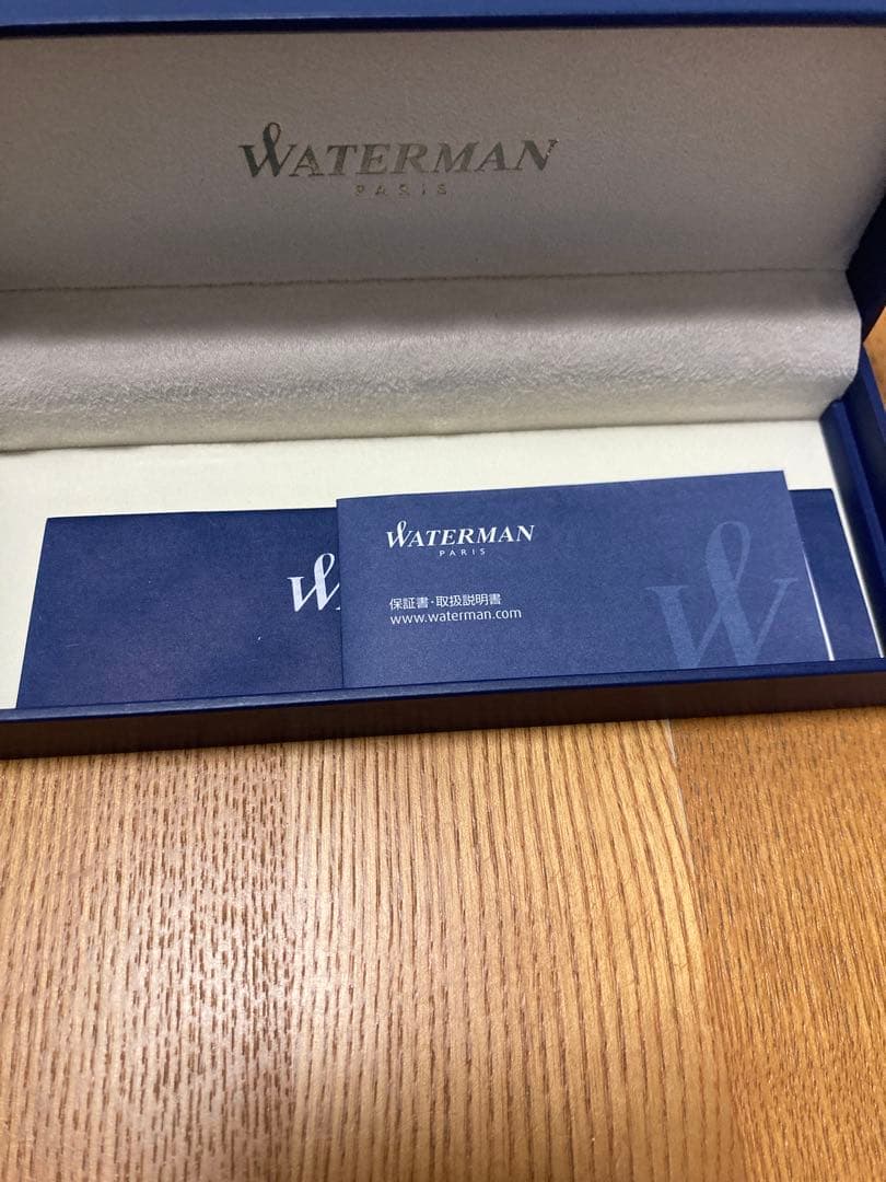 WATERMAN ballpoint pen with engraved organization name on the body, shown in close-up