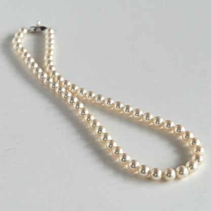 Takashi Akoya pearl necklace with 7.5mm round pearls and a K14 gold fastener on a white background