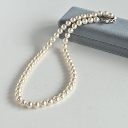 Takashi Akoya pearl necklace with 7.5mm round pearls and a K14 gold fastener on a white background