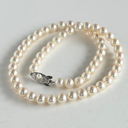 Takashi Akoya pearl necklace with 7.5mm round pearls and a K14 gold fastener on a white background