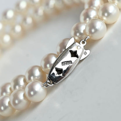 Takashi Akoya pearl necklace with 7.5mm round pearls and a K14 gold fastener on a white background