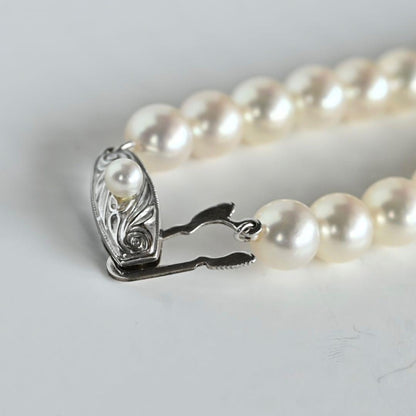 Takashi Akoya pearl necklace with 7.5mm round pearls and a K14 gold fastener on a white background