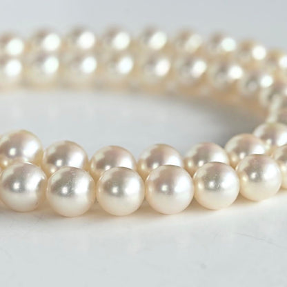 Takashi Akoya pearl necklace with 7.5mm round pearls and a K14 gold fastener on a white background