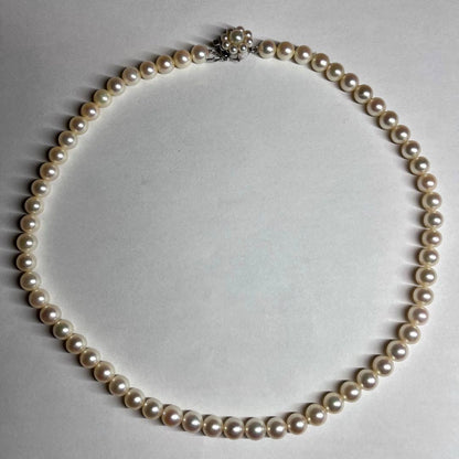 Polished Akoya pearl necklace with 6.5-7mm pearls, approximately 43 cm long, displayed on a white background