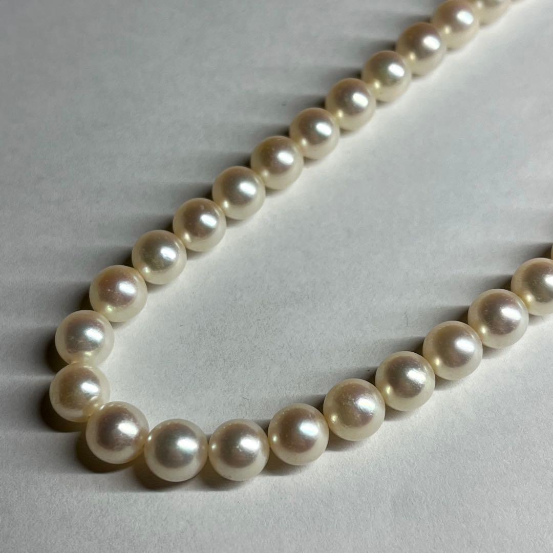 Polished Akoya pearl necklace with 6.5-7mm pearls, approximately 43 cm long, displayed on a white background