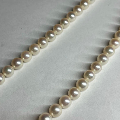 Polished Akoya pearl necklace with 6.5-7mm pearls, approximately 43 cm long, displayed on a white background