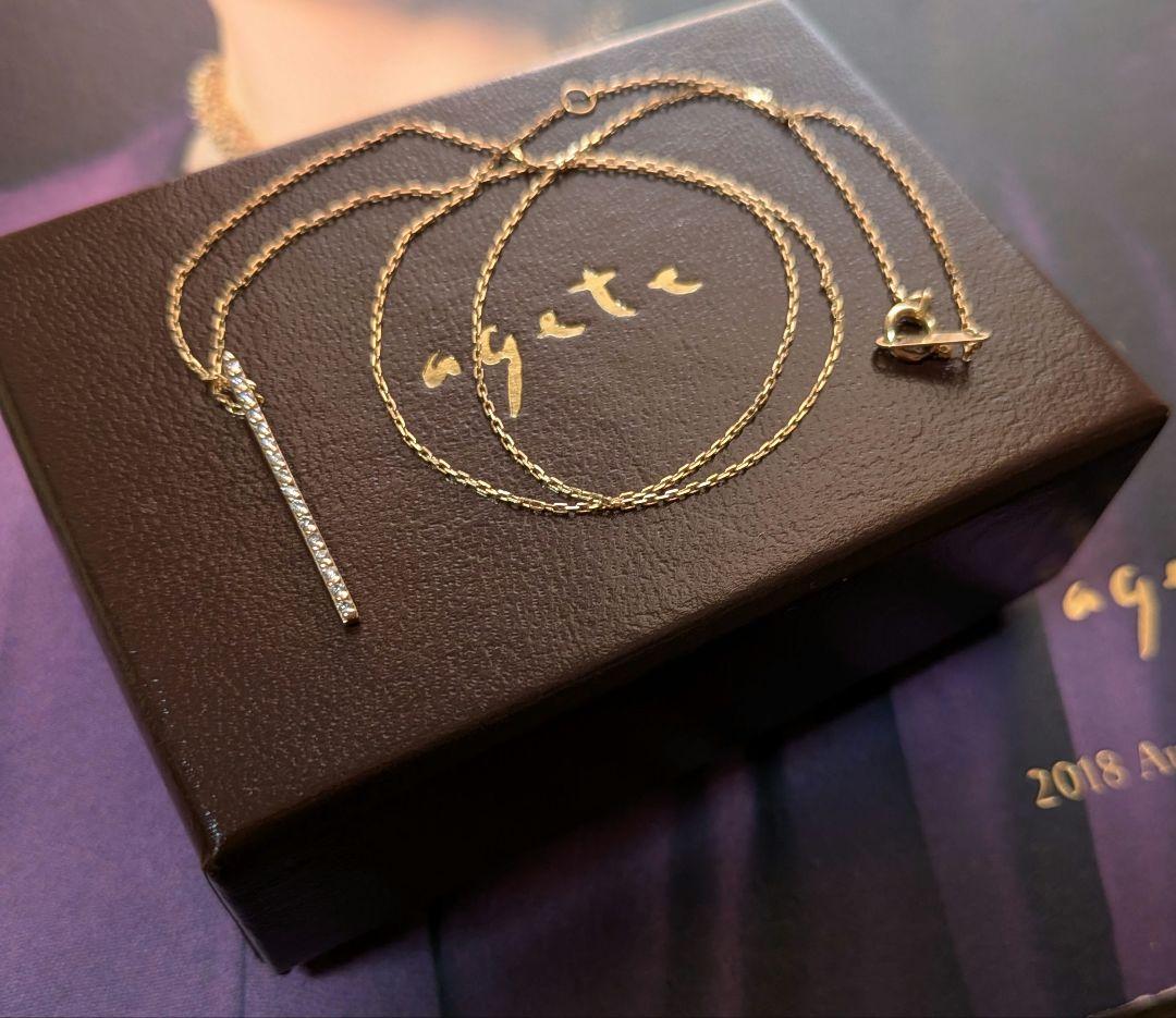 Agat K10 gold diamond bar necklace with 0.08 carat diamonds on a chain with engraving, displayed with box