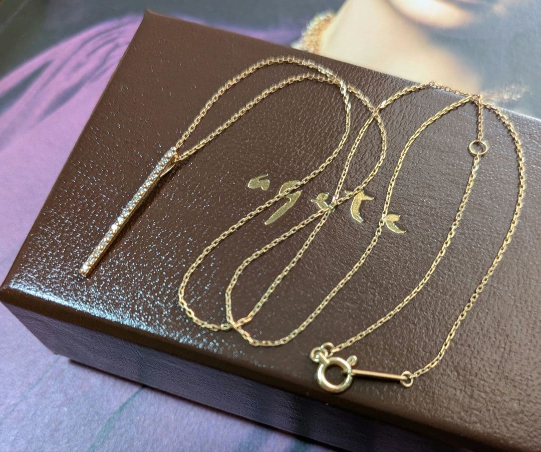 Agat K10 gold diamond bar necklace with 0.08 carat diamonds on a chain with engraving, displayed with box