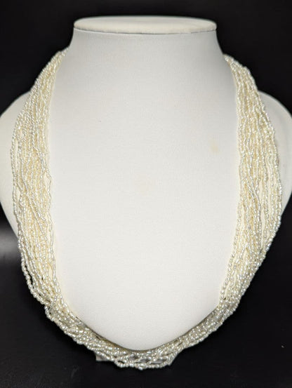 N107 Poppy 15-Strand Akoya Pearl Necklace with 2-4mm pearls and 62cm length displayed on a white background