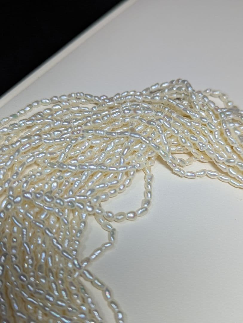 N107 Poppy 15-Strand Akoya Pearl Necklace with 2-4mm pearls and 62cm length displayed on a white background