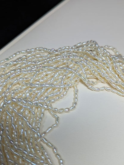 N107 Poppy 15-Strand Akoya Pearl Necklace with 2-4mm pearls and 62cm length displayed on a white background