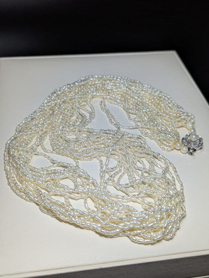 N107 Poppy 15-Strand Akoya Pearl Necklace with 2-4mm pearls and 62cm length displayed on a white background