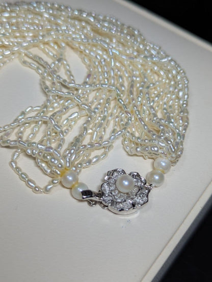 N107 Poppy 15-Strand Akoya Pearl Necklace with 2-4mm pearls and 62cm length displayed on a white background