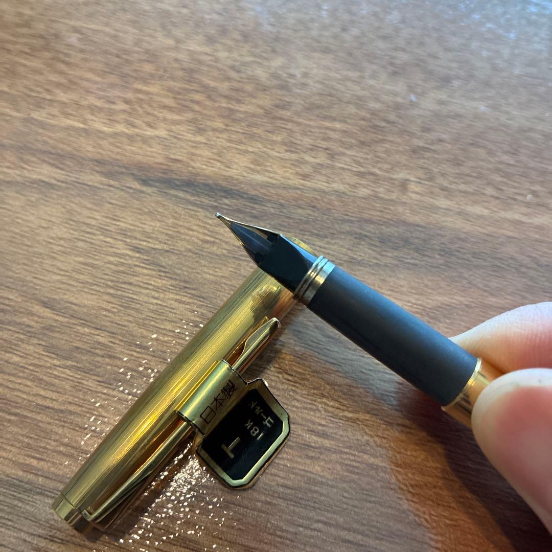 New PILOT fountain pen featuring an 18K gold nib with sleek black body and silver accents