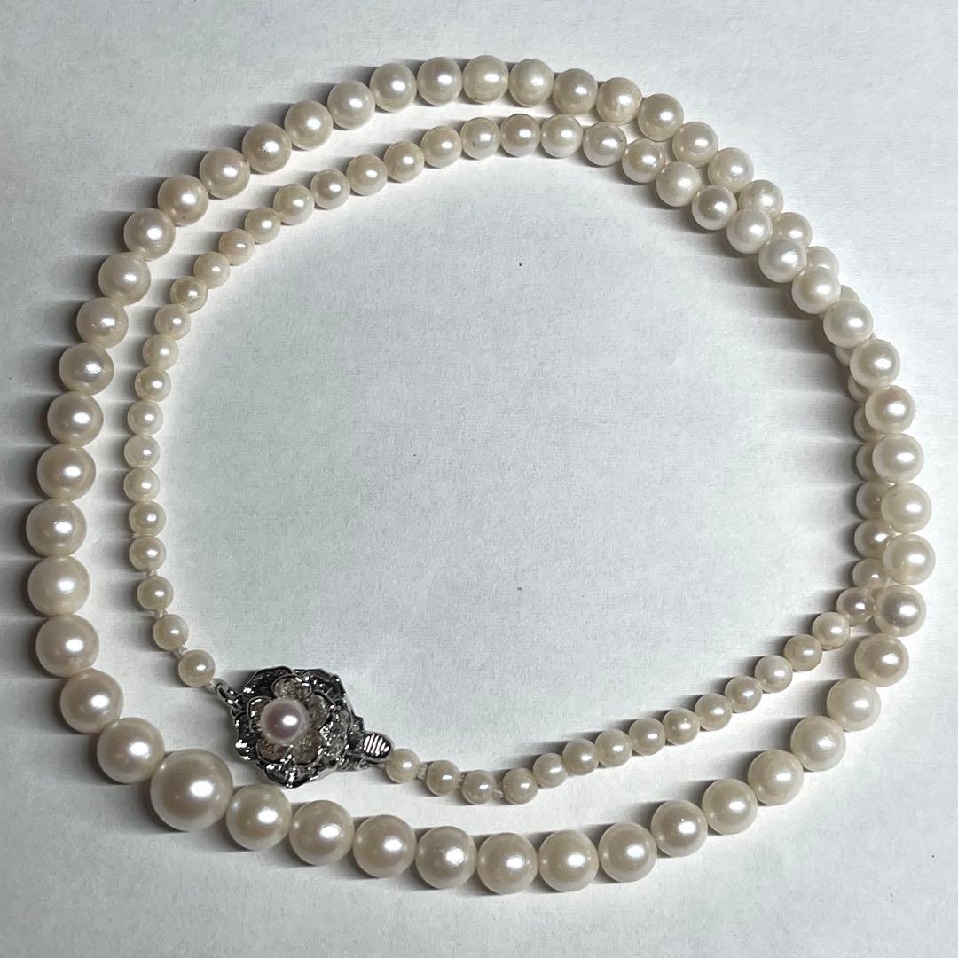 Aoya pearl necklace with cream baroque pearls and silver clasp on white background