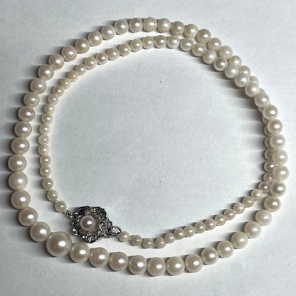 Aoya pearl necklace with cream baroque pearls and silver clasp on white background