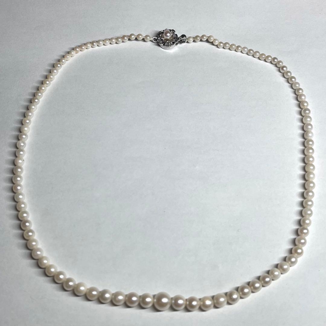 Aoya pearl necklace with cream baroque pearls and silver clasp on white background