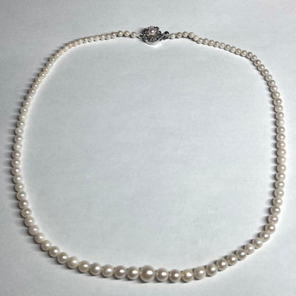 Aoya pearl necklace with cream baroque pearls and silver clasp on white background