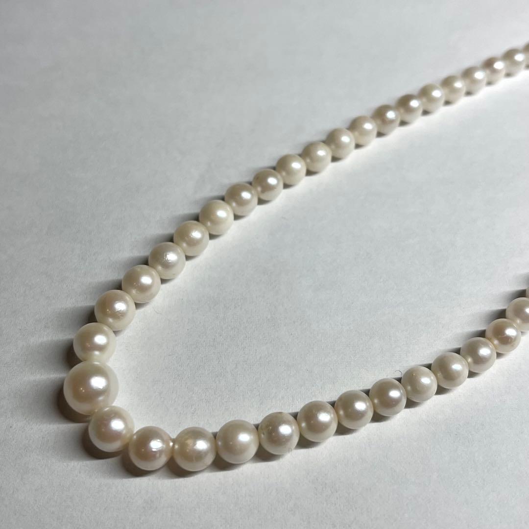 Aoya pearl necklace with cream baroque pearls and silver clasp on white background