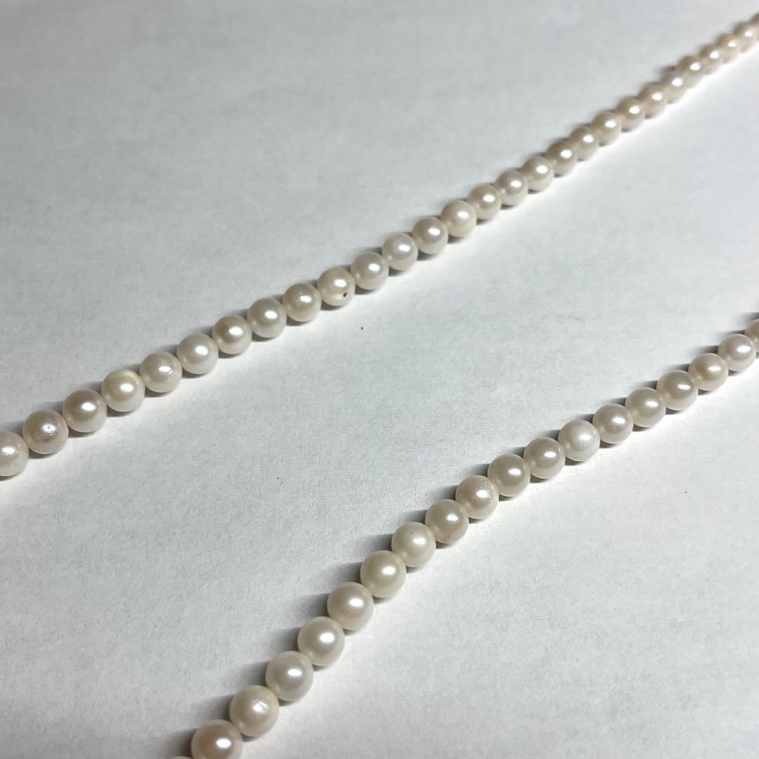Aoya pearl necklace with cream baroque pearls and silver clasp on white background