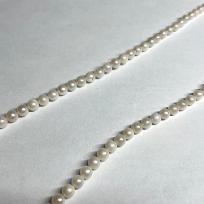 Aoya pearl necklace with cream baroque pearls and silver clasp on white background