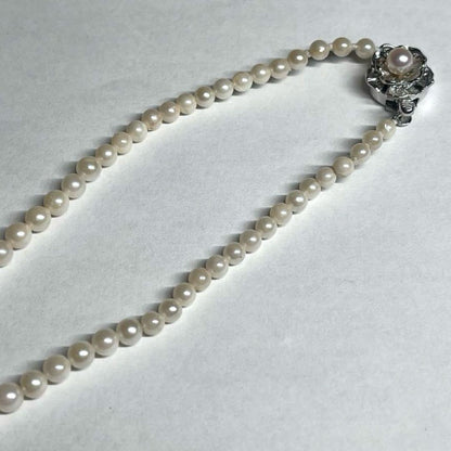 Aoya pearl necklace with cream baroque pearls and silver clasp on white background