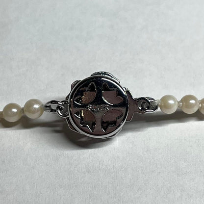 Aoya pearl necklace with cream baroque pearls and silver clasp on white background