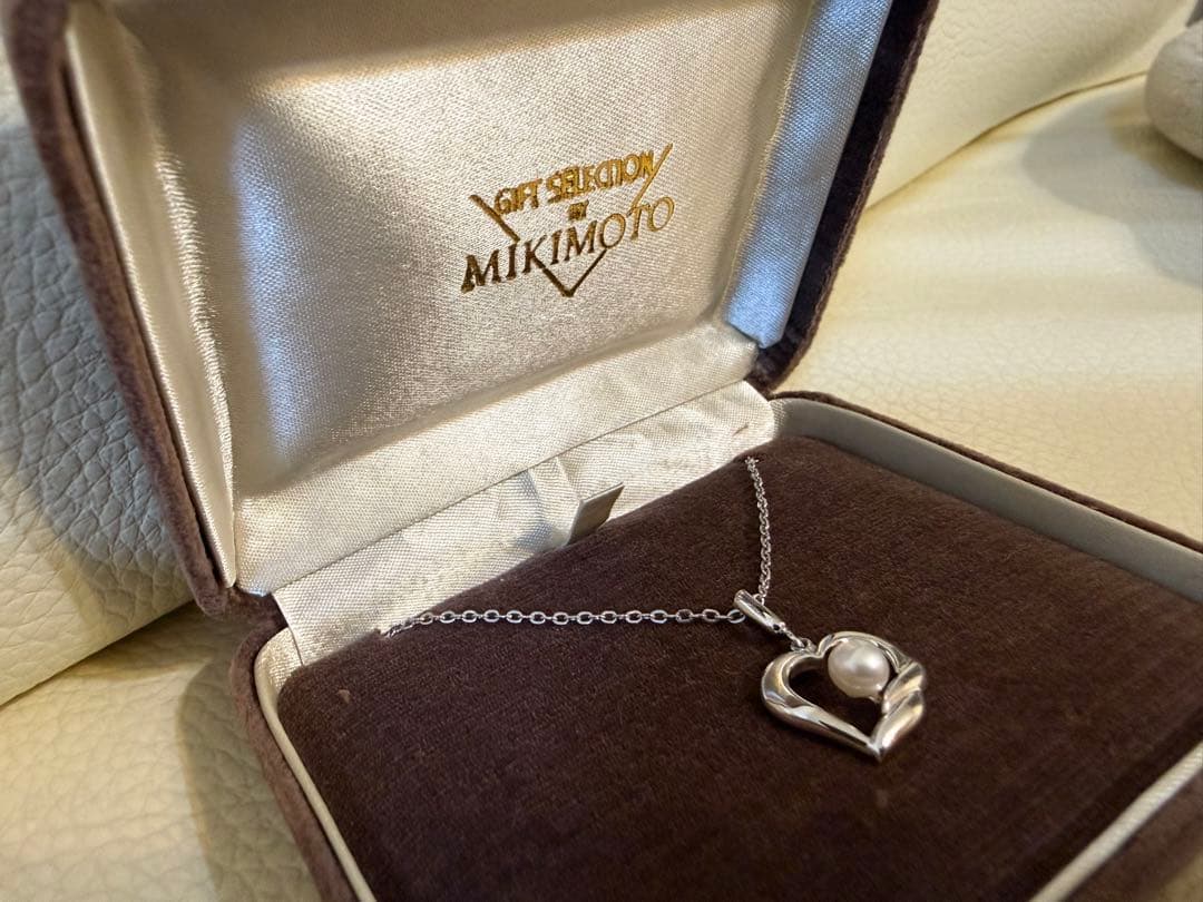 MIKIMOTO heart-shaped pearl necklace with silver pendant on white background