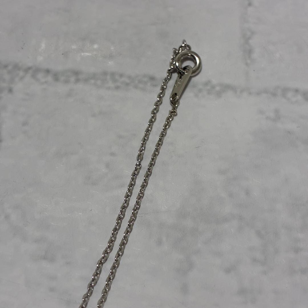 Mikimoto necklace featuring a silver white ribbon pendant with Akoya pearl on a 40 cm chain