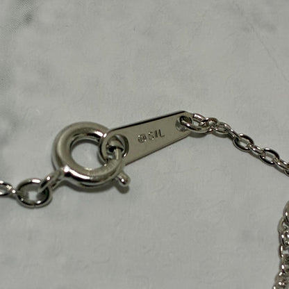 Mikimoto necklace featuring a silver white ribbon pendant with Akoya pearl on a 40 cm chain