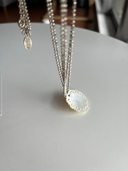 Agete shell necklace featuring natural shell pendant on delicate chain