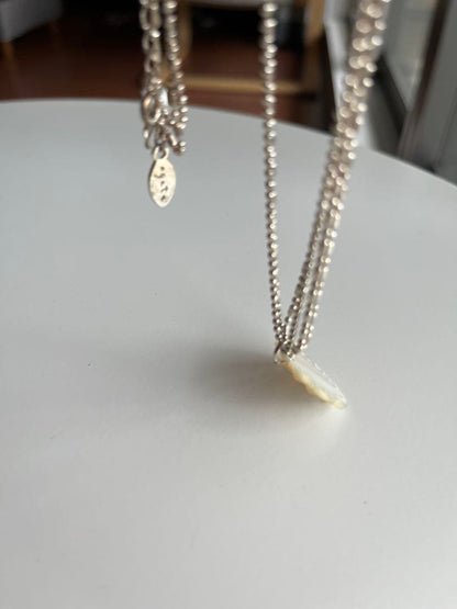 Agete shell necklace featuring natural shell pendant on delicate chain