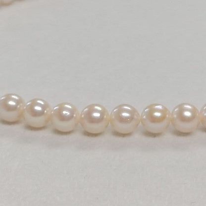 Law Akoya cultured pearl necklace with 6.5-7mm round white to cream pearls and silver clasp on a white background