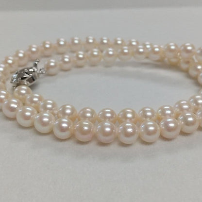 Law Akoya cultured pearl necklace with 6.5-7mm round white to cream pearls and silver clasp on a white background