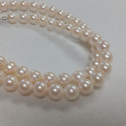 Law Akoya cultured pearl necklace with 6.5-7mm round white to cream pearls and silver clasp on a white background