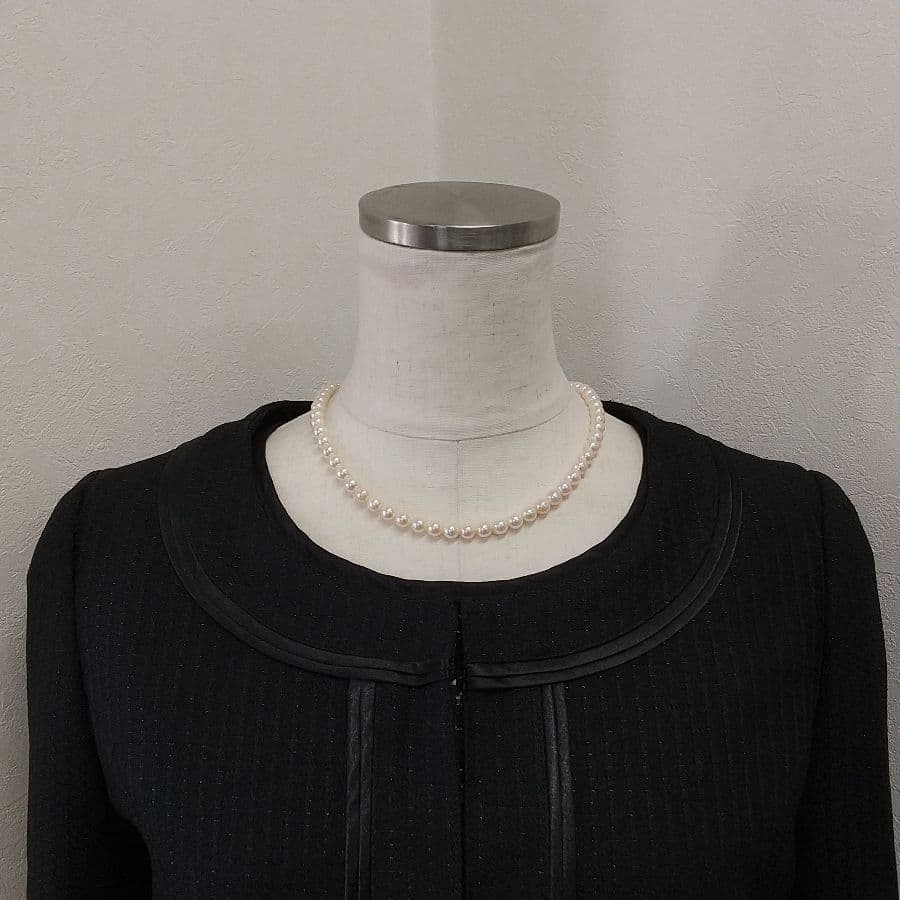 Law Akoya cultured pearl necklace with 6.5-7mm round white to cream pearls and silver clasp on a white background
