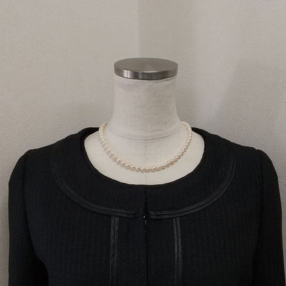 Law Akoya cultured pearl necklace with 6.5-7mm round white to cream pearls and silver clasp on a white background