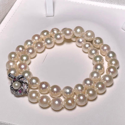 Oyster pearl necklace with round white pearls sized 8.3-8.8mm and ruby clasp with silver stamp