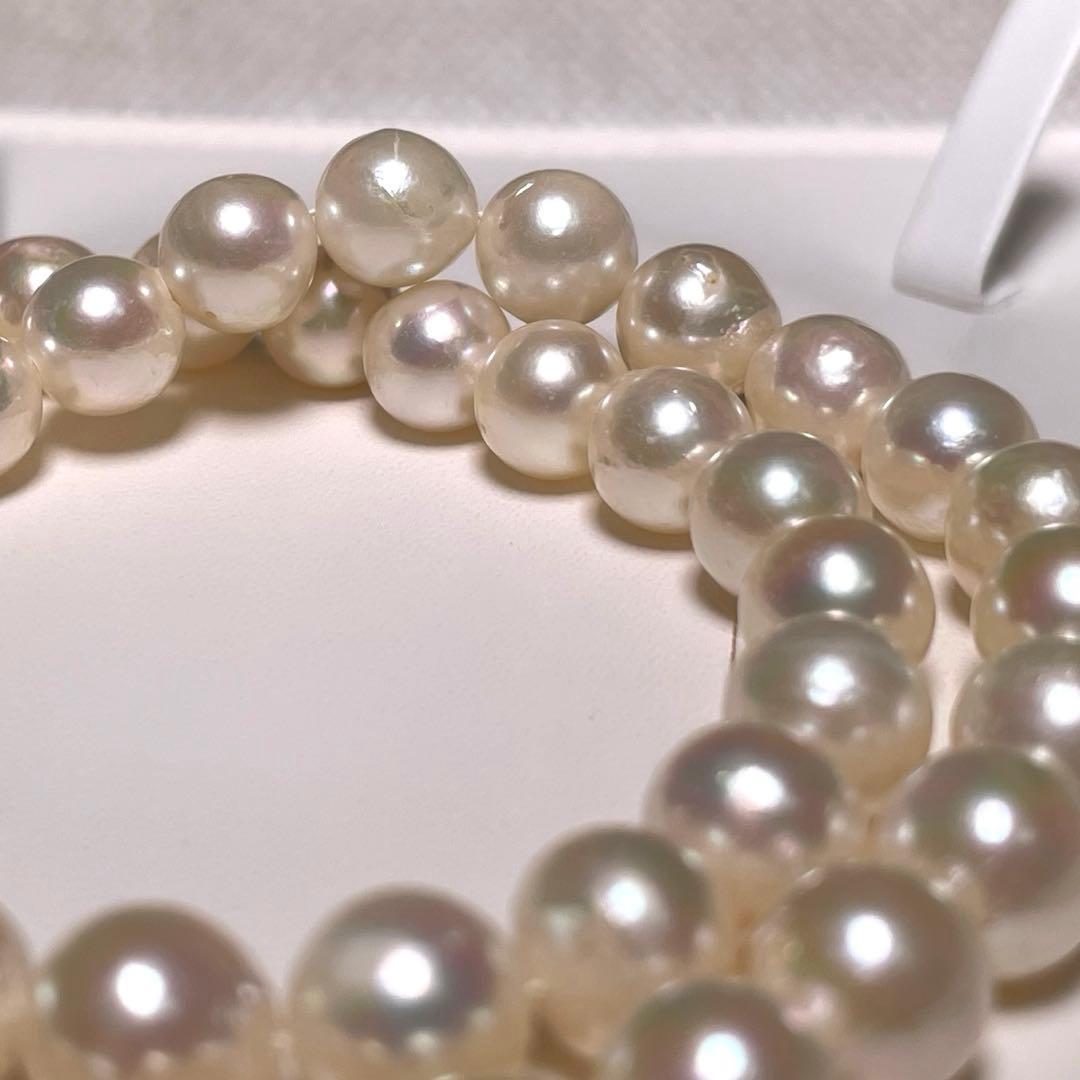 Oyster pearl necklace with round white pearls sized 8.3-8.8mm and ruby clasp with silver stamp