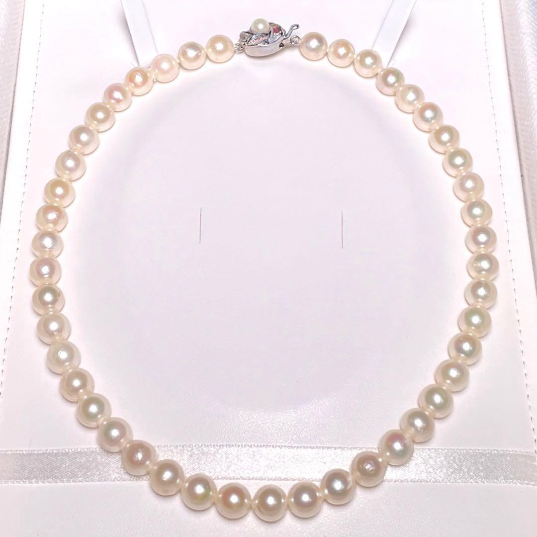Oyster pearl necklace with round white pearls sized 8.3-8.8mm and ruby clasp with silver stamp