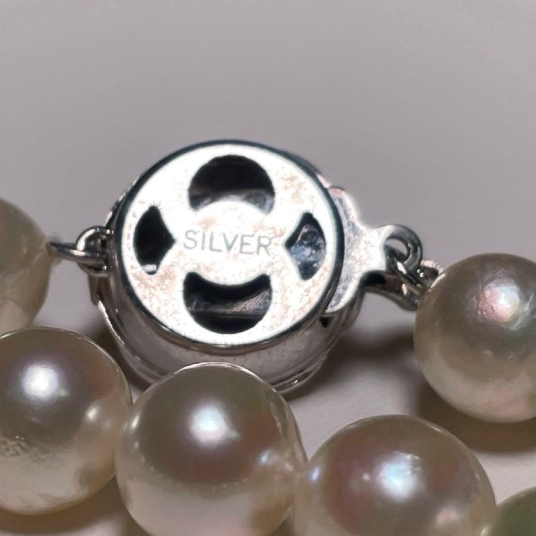 Oyster pearl necklace with round white pearls sized 8.3-8.8mm and ruby clasp with silver stamp