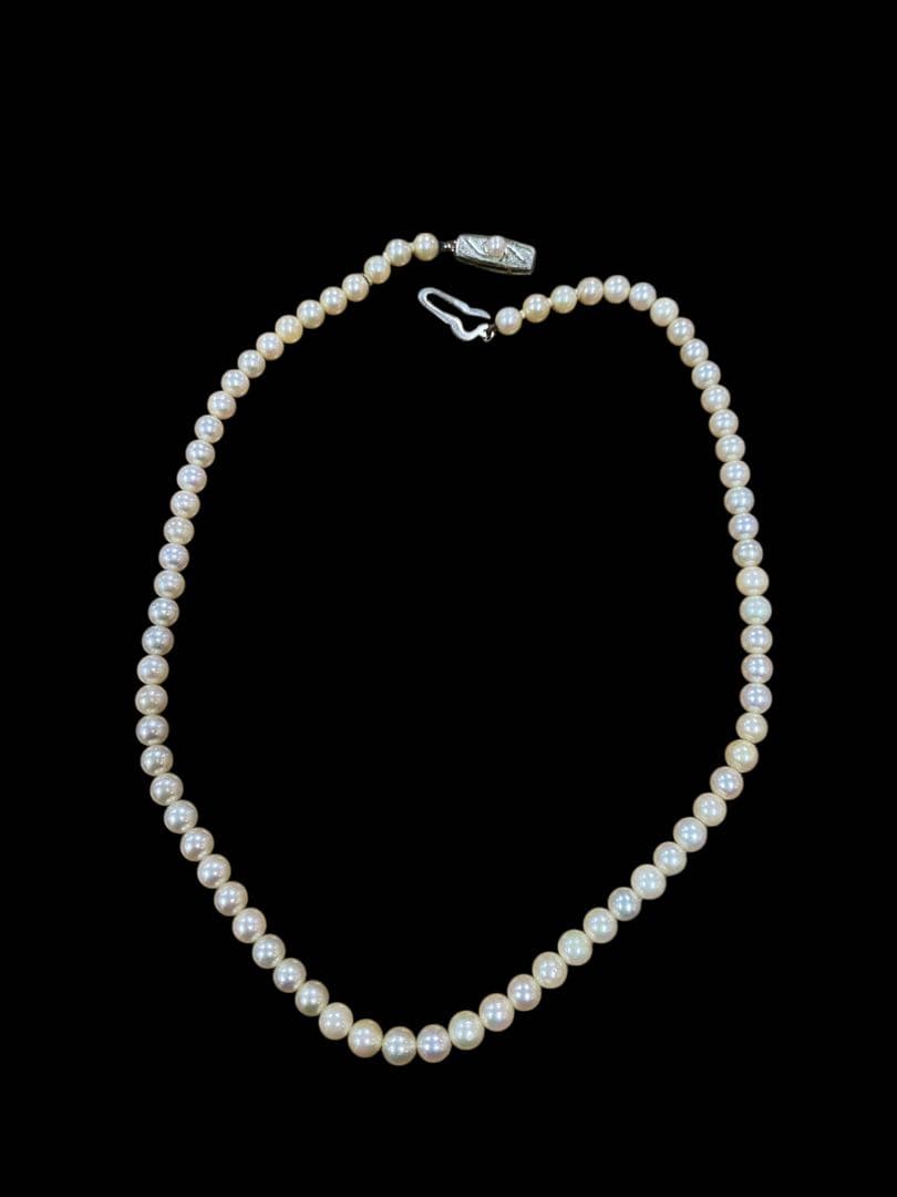 Akoya pearl necklace featuring 5.1mm pearls with silver mark setting on a 41 cm chain