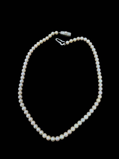Akoya pearl necklace featuring 5.1mm pearls with silver mark setting on a 41 cm chain