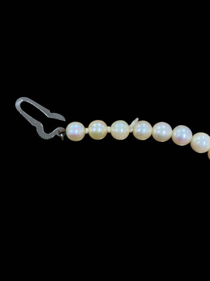 Akoya pearl necklace featuring 5.1mm pearls with silver mark setting on a 41 cm chain