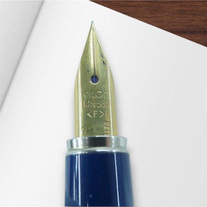 Pilot U fountain pen with 14K-585 fine tip in silver and gold color displayed with genuine case